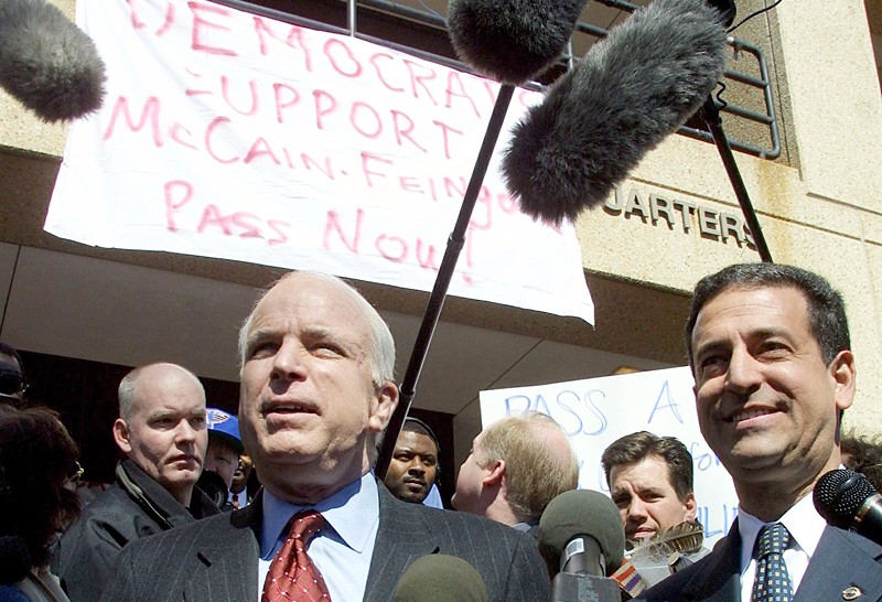 Sens. John McCain and Russ Feingold (D-WI) hold a press conference on campaign finance reform outside the Democratic National Committee in 2001.