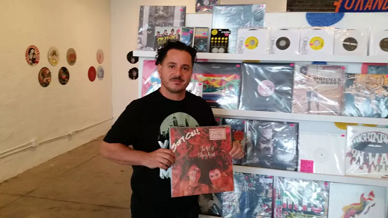 Image: Konstadinos "Cocoe" Tsimahidis holds up a killer Soft Cell record at his Grand Avenue Records store. It's probably already sold.