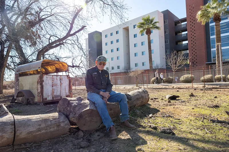 Image: Gail Palmer, a.k.a. the “Cow Guy,” on his Colter Street property, which is surrounded by Grand Canyon University.