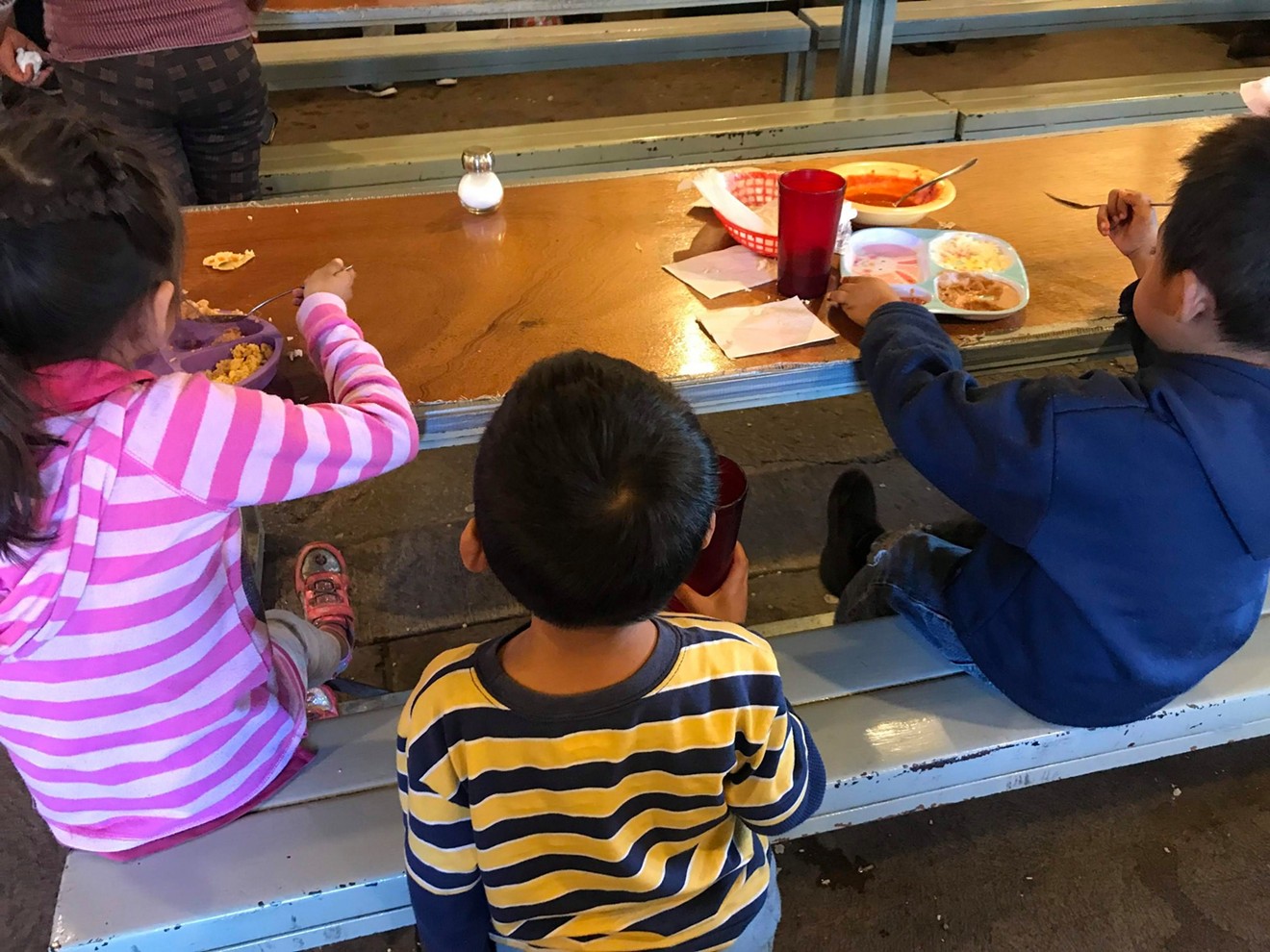 Children receive meals at Kino Border Initiative's aid center for migrants in Nogales, Sonora.