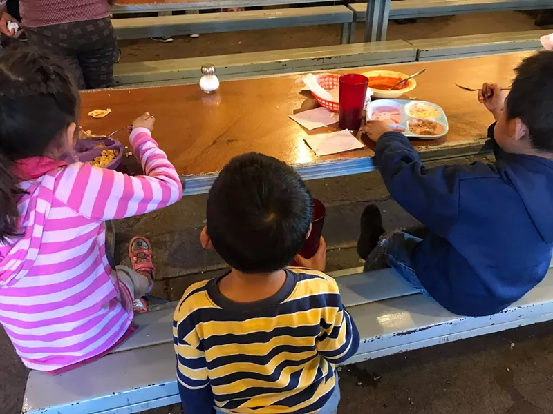 Image: Children receive meals at Kino Border Initiative's aid center for migrants in Nogales, Sonora.