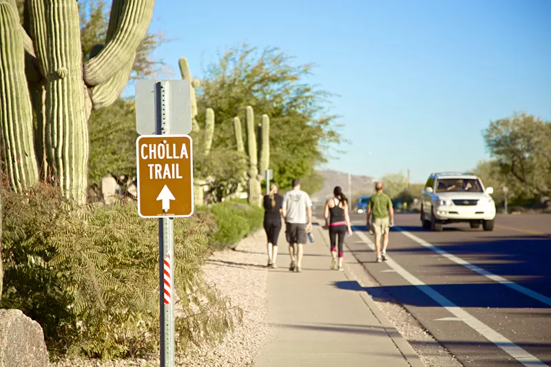 Image: Hikers walking on Invergordon Road to Cholla Lane. Could new renovation at the Phoenician Resort lead to a relocation of the start of Camelback Mountain's popular Cholla Trail? Some of the area's neighbors hope so.