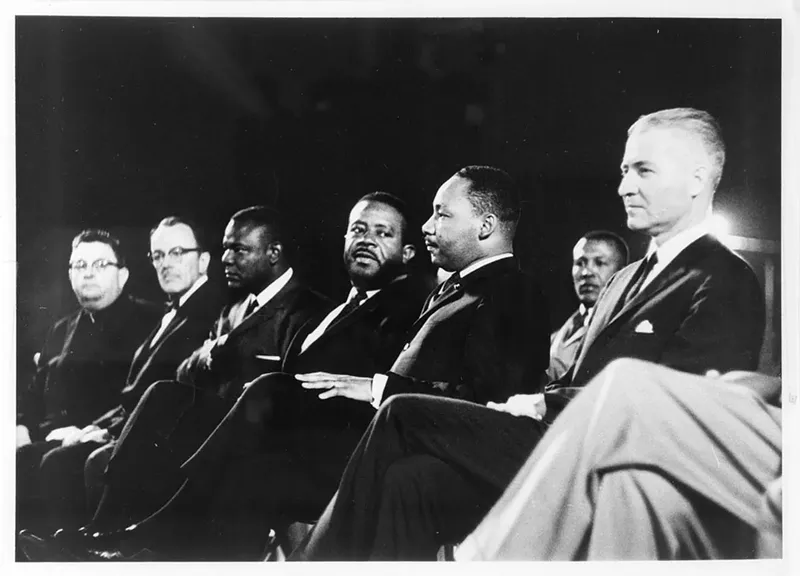 Image: G. Homer Durham, Martin Luther King, Jr., Ralph Abernathy, an unidentified participant, Rev. Louis Eaton, and Msgr. Robert Donohoe at Arizona State University's Goodwin Stadium in 1964. King was invited by the Maricopa County chapter of the NAACP to deliver a speech to a crowd of 8,000 people at Arizona State University.