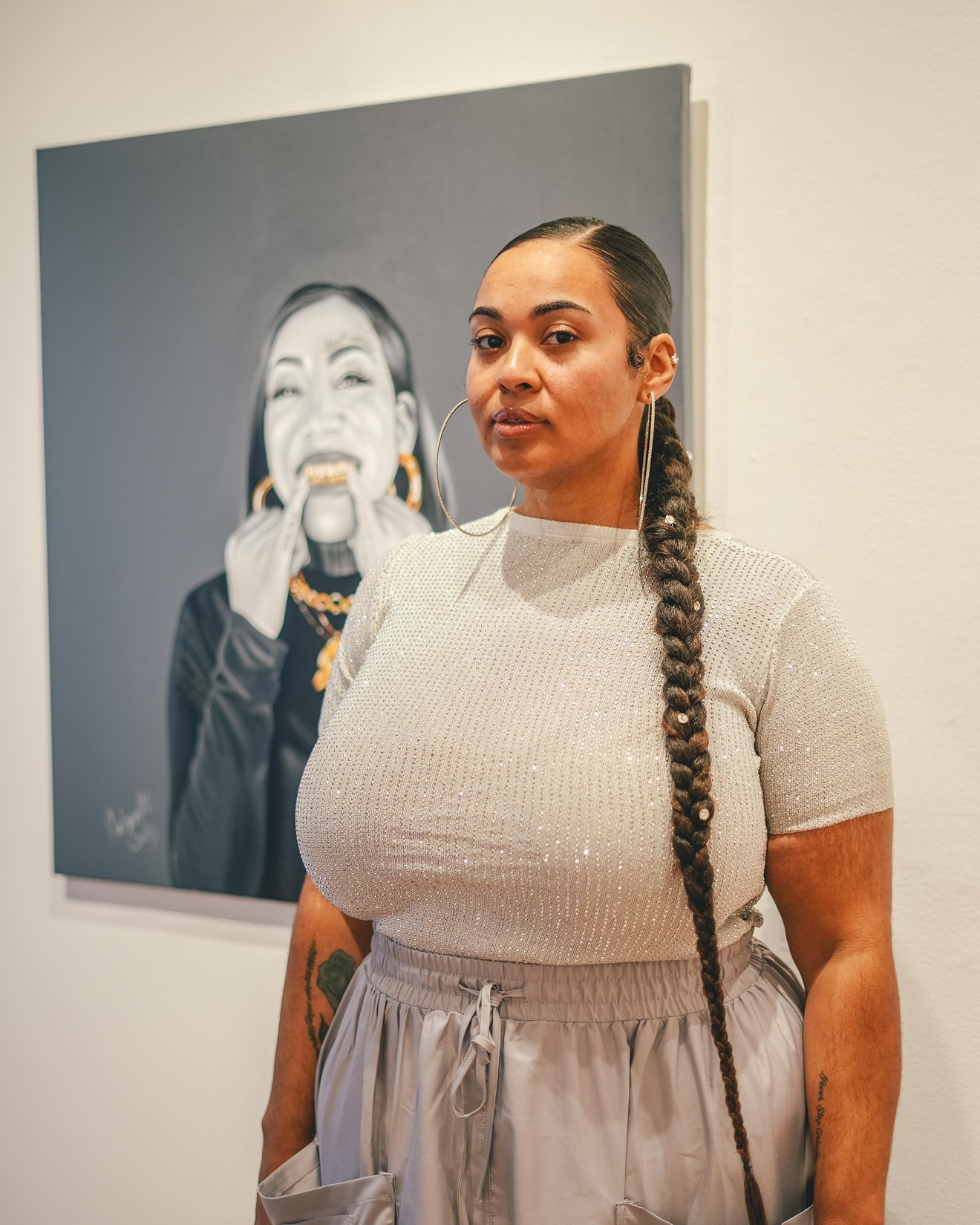 Artist Antoinette Cauley poses with a piece from "I Do It for the Hood Part 2."