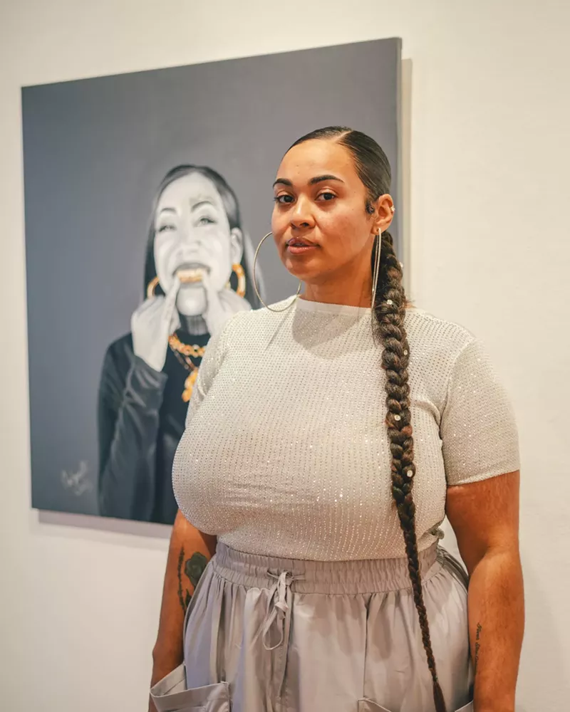 Image: Artist Antoinette Cauley poses with a piece from "I Do It for the Hood Part 2."