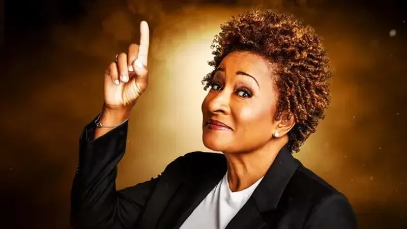 Image: A Black woman pointing up.