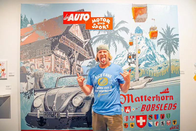 Image: "Chaos Theory" organizer Randy Slack poses with one of his paintings.