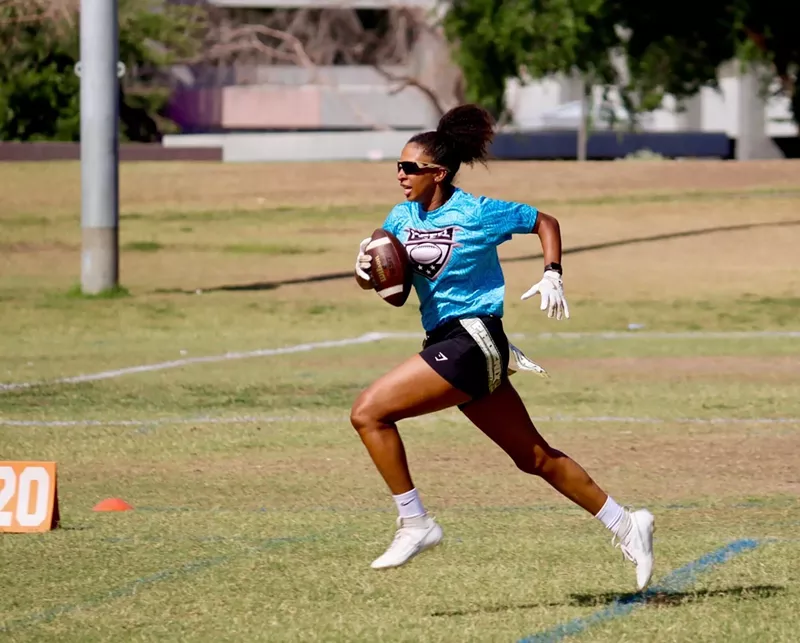 Image: Cydeni Carter, sprinting with a football in a Phoenix Gay Flag Football League game, says she enjoys the league because there are “people who are around me who are just like me.”