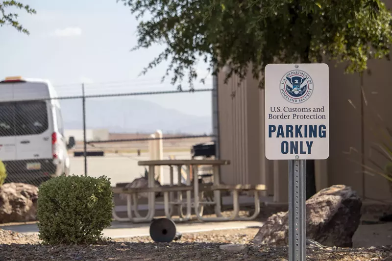 Image: an customs and border protection parking sign in front of a building