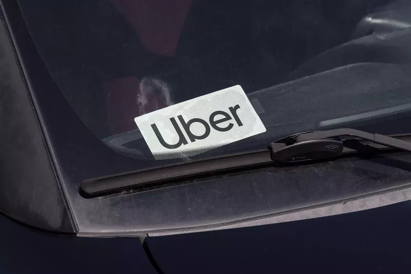 Image: an uber logo in the windshield of a car