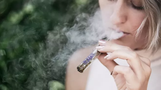 someone smoking weed out of a pipe