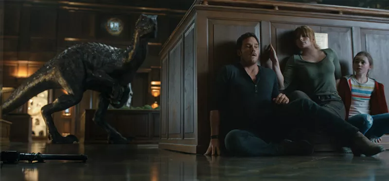 Image: A new hybrid dinosaur called the Indoraptor threatens (from left) Owen Grady (Chris Pratt), Claire Dearing (Bryce Dallas Howard), and Maisie Lockwood (Isabella Sermon) in Jurassic World: Fallen Kingdom.