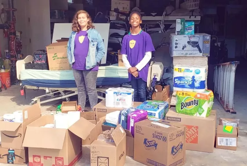 Image: Neighbors Helping Neighbors prep a delivery for an assisted living facility.
