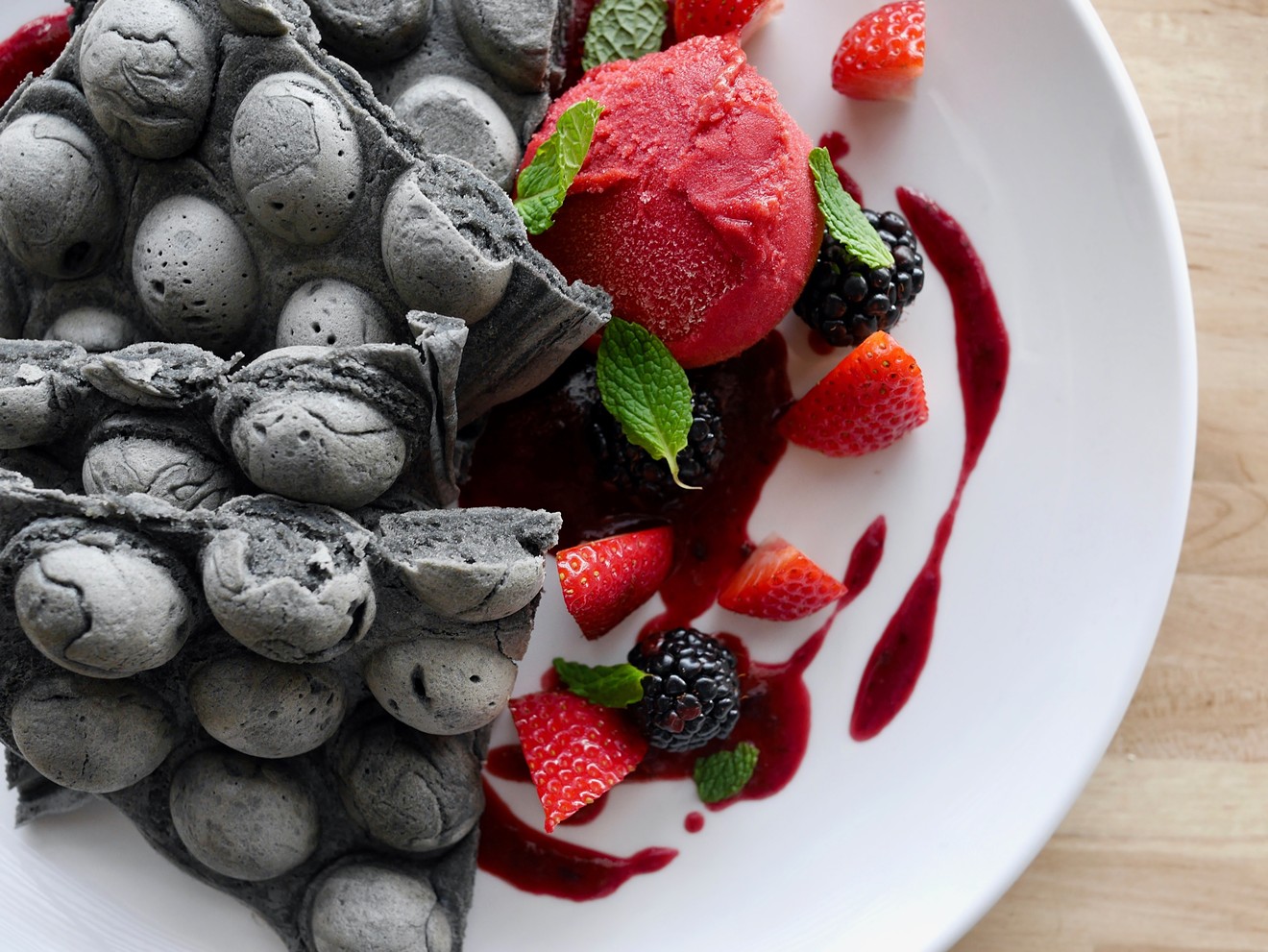 "Goth waffles" made with activated charcoal and topped with fresh fruit.