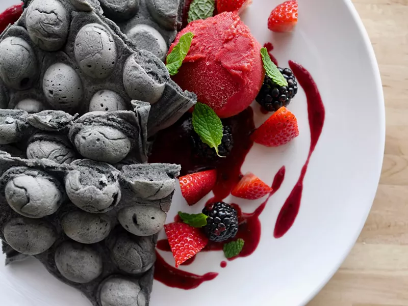 Image: "Goth waffles" made with activated charcoal and topped with fresh fruit.