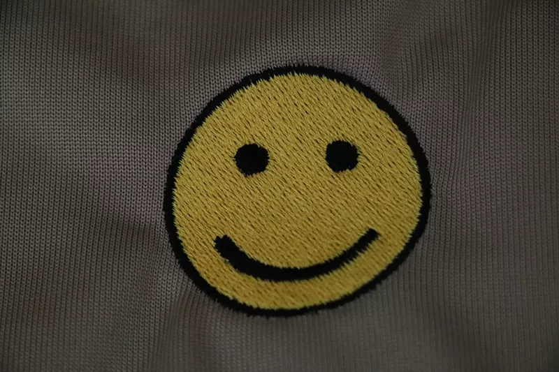 Image: Smiley faces stitched on the back of hundreds of Arizona Department of Economic Security uniforms will be covered with Arizona flags, the agency said on Thursday.