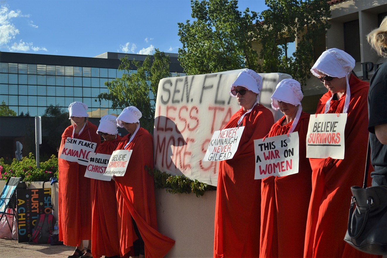 Outside the Phoenix offices of Arizona Senator Jeff Flake, members of the Handmaids Resistance quietly protested all day Thursday.