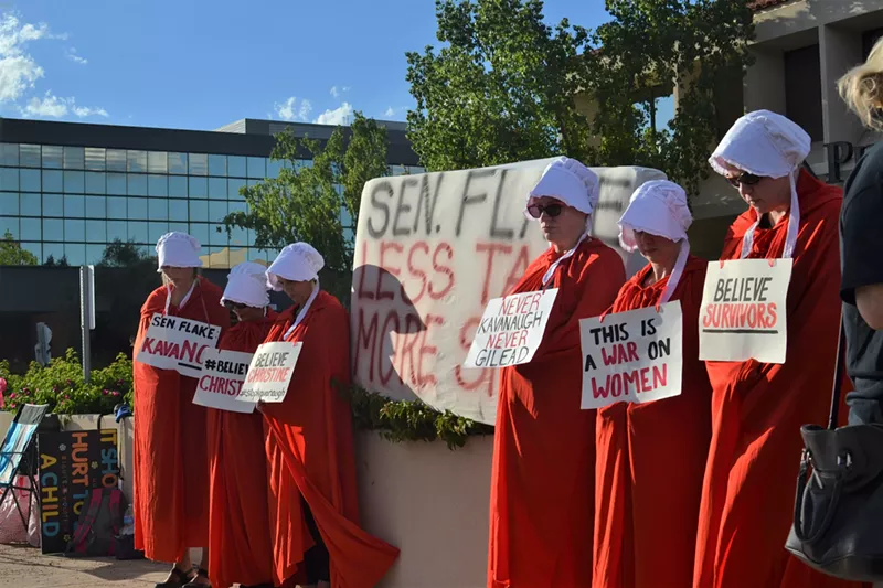 Image: Outside the Phoenix offices of Arizona Senator Jeff Flake, members of the Handmaids Resistance quietly protested all day Thursday.