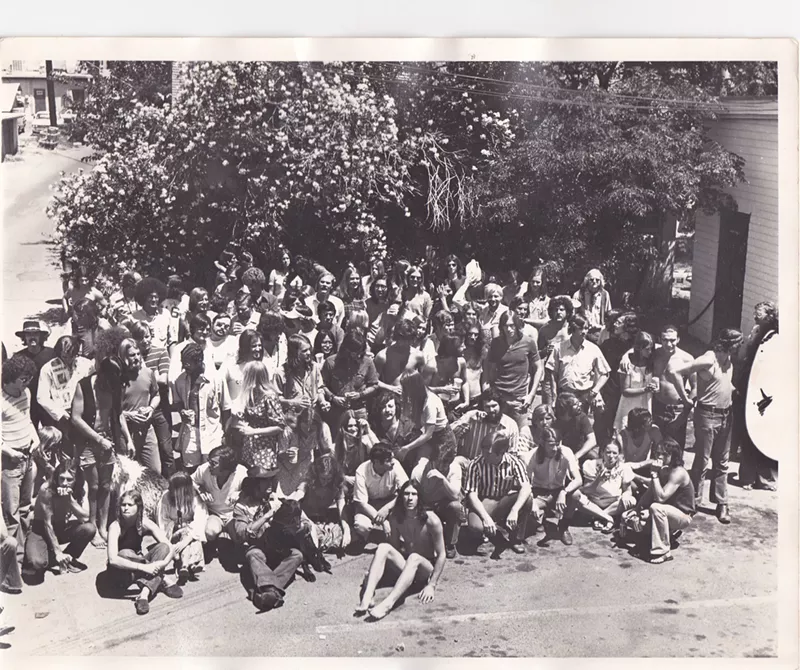 Image: New Times staff, friends, and assorted revelers at its one-year anniversary party in 1971, including a seated, long-haired Mike Lacey, in the center of the second full row.