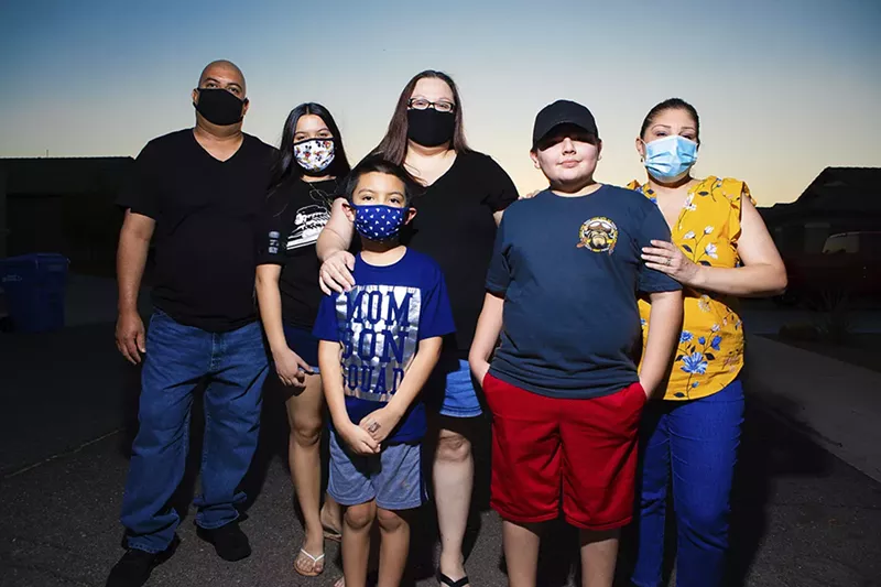 Image: Jessica Beltran (center) and Teresa Rodriguez (right) pose with their families, Sept. 24.