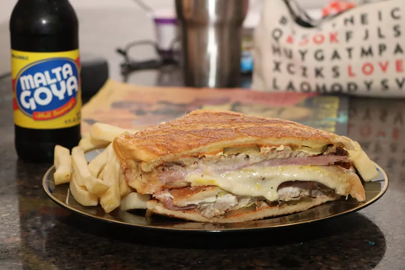 Image: Los Kaciques' grilled Cuban ham and cheese sandwich pairs perfectly with Malta Goya.