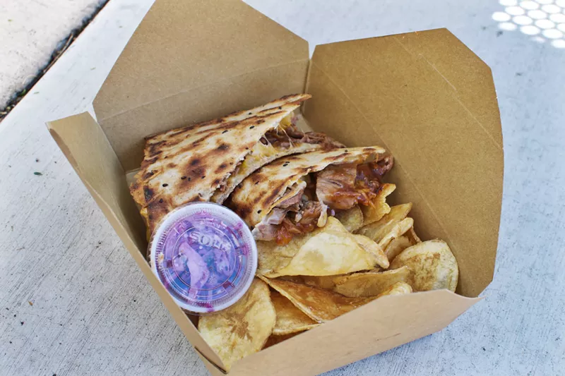 Image: The Barbecue Brisket sandwich from Paradise Melts is slow-roasted beef brisket, cheddar, and jack cheese, and house-made Tennessee barbecue sauce on Persian sangak bread. The slaw and house-made chips are not bad, either.