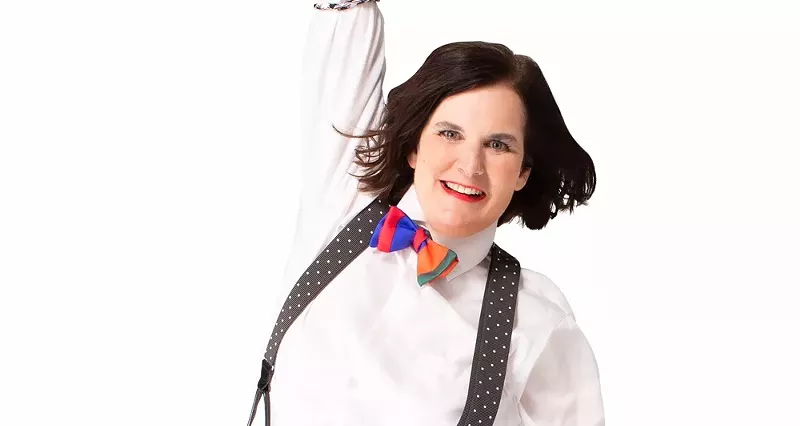 Image: A women in a bow tie and suspenders.