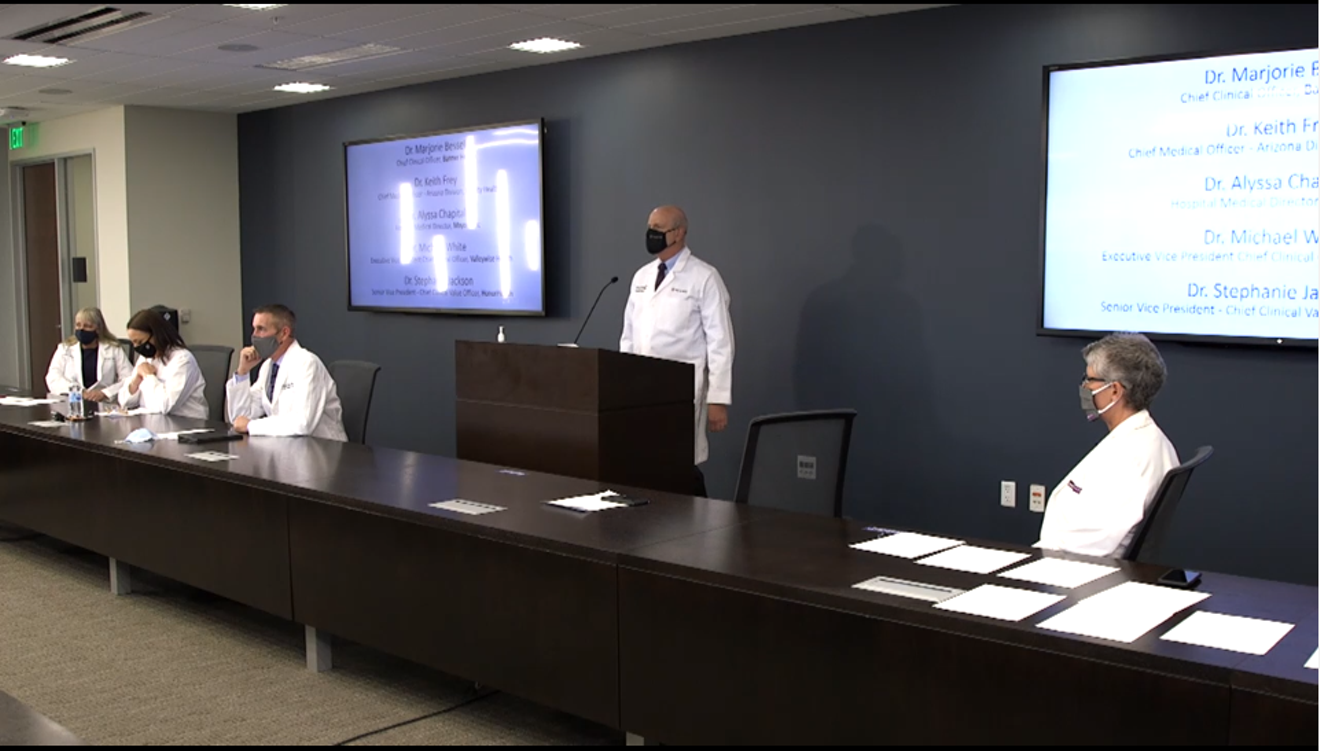 Dr. Keith Frey, Dignity Health Chief Medical Officer - Arizona Division, speaks at a virtual press conference. Around him are top doctors from Arizona healthcare systems.