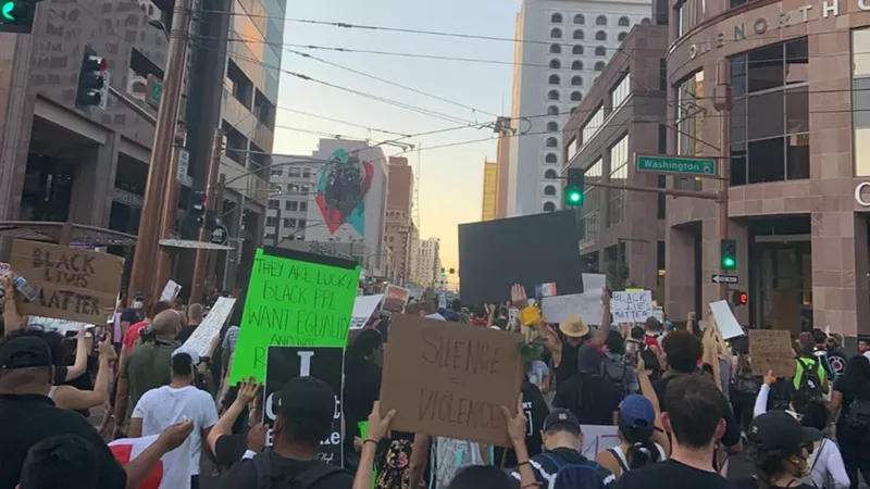 Image: Protestors at a recent march for Dion Johnson, a 29-year old black man killed during an arrest in Phoenix.