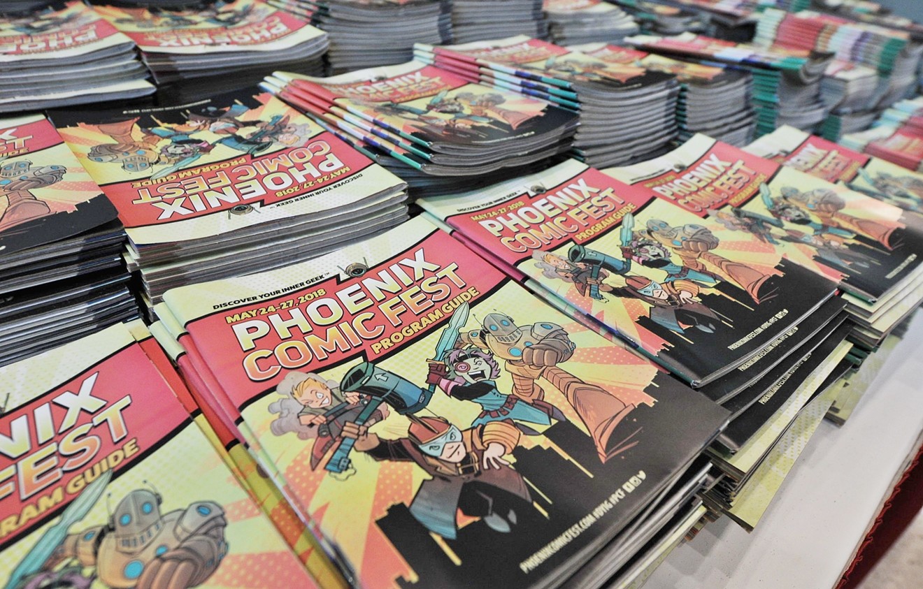 Stacks of Phoenix Comic Fest programming guides at this year's event.