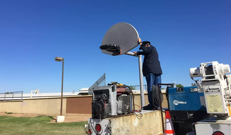 Image: A city staffer works at Madison Park in Phoenix this week. Some worry that current restrictions aren't enough to keep workers safe from the coronavirus.