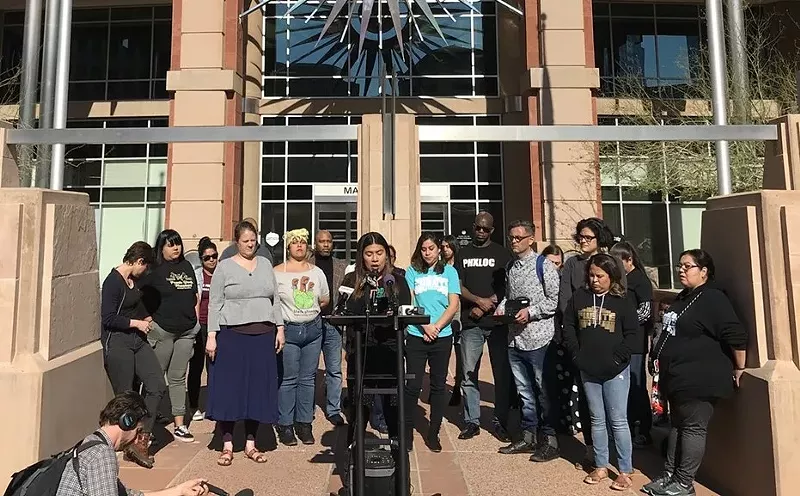 Image: Community groups speak outside City Hall on Monday.