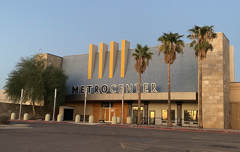 The entrance to a defunct shopping mall at sunset.