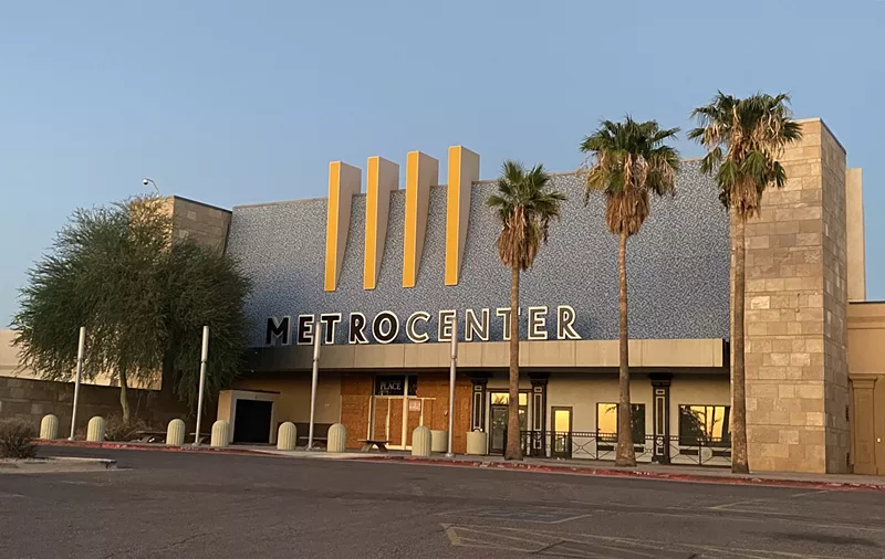 Image: The entrance to a defunct shopping mall at sunset.