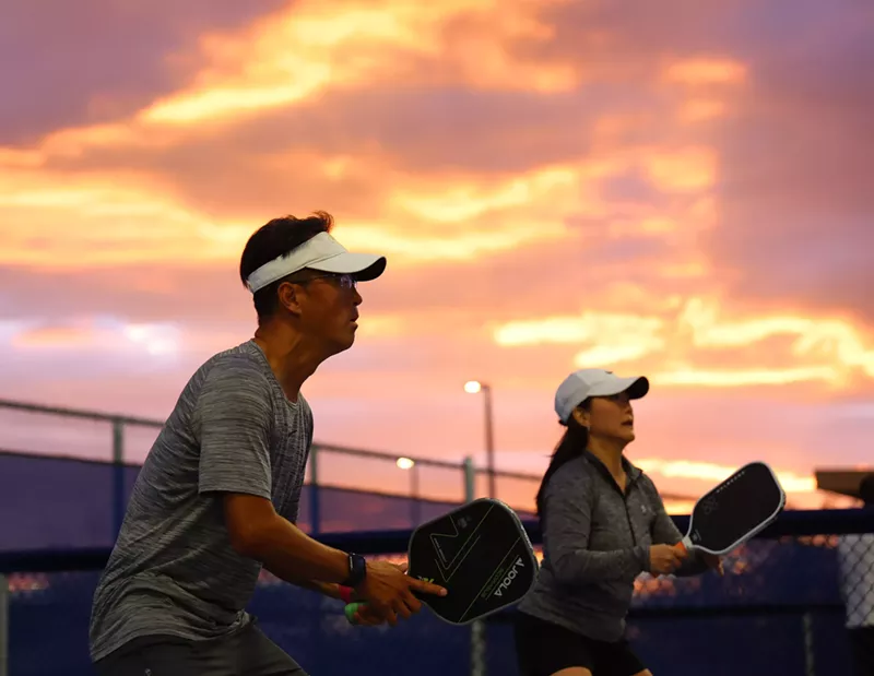Image: Pickball players like Dan Shin, left, and his wife, Theresa, can play in competitive matches until 10 p.m. at Gilbert Regional Park.