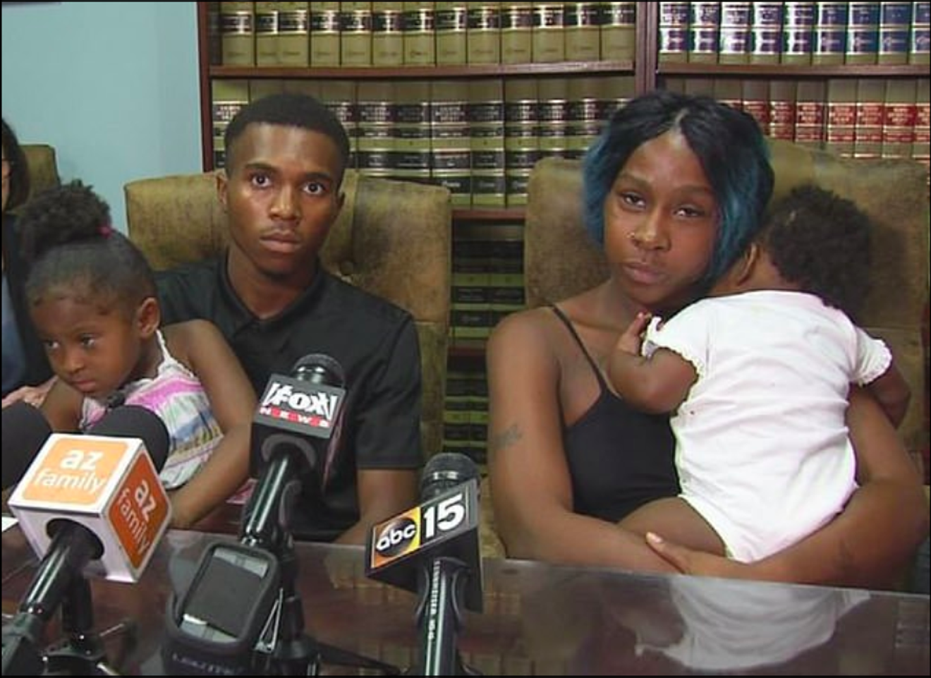 Dravon Ames, Iesha Harper, and their children at a press conference.
