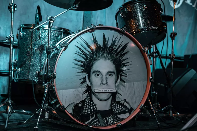Image: A drum kit with a man's face on the bass drum.