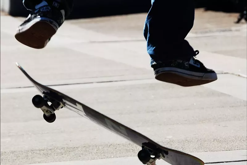 Image: A person on a skateboard in mid-air.