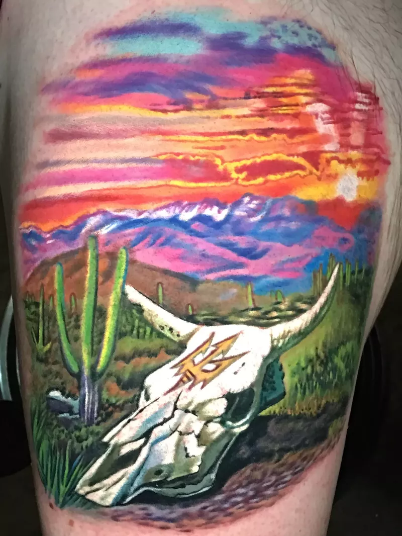 Image: A tattoo of a cow skull in the desert.