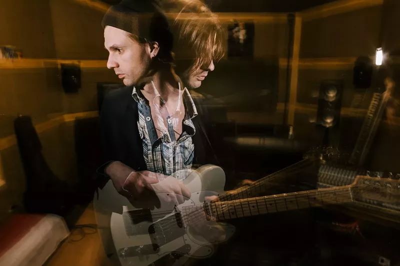 Image: Guitarist in double exposure. Split personality. Musical recording studio, dark heavy music and psychological condition.