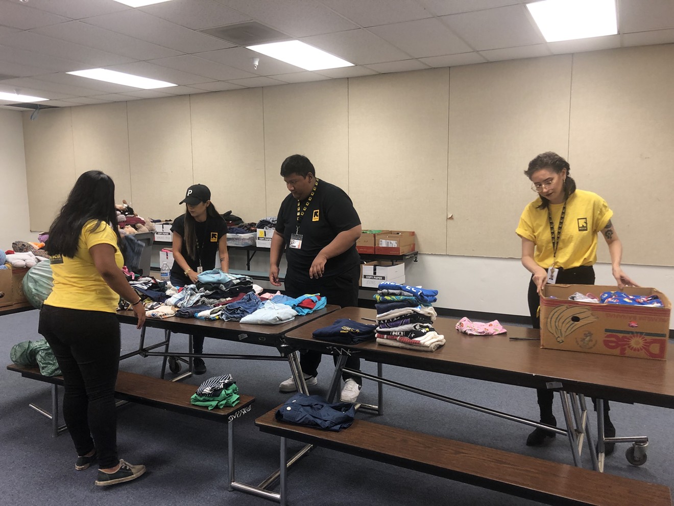 International Rescue Committee volunteers sort through clothing donations ahead of the arrival of 70 migrants. Most of the clothing was given by individual donors or church groups.