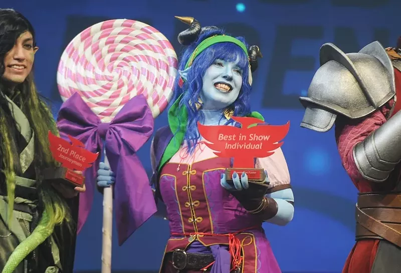 Image: Tucson cosplayer Pat Fielder (center) with the individual “Best in Show” trophy she won at Phoenix Fan Fusion’s masquerade ball.