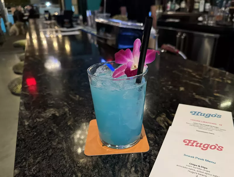 Image: Blue cocktail and menu at Hugo's Cantina.