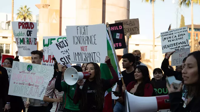 protesters hold up pro-immigrant signs