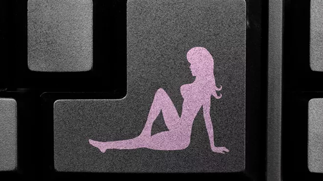 a silhouette of a naked woman on a computer keyboard