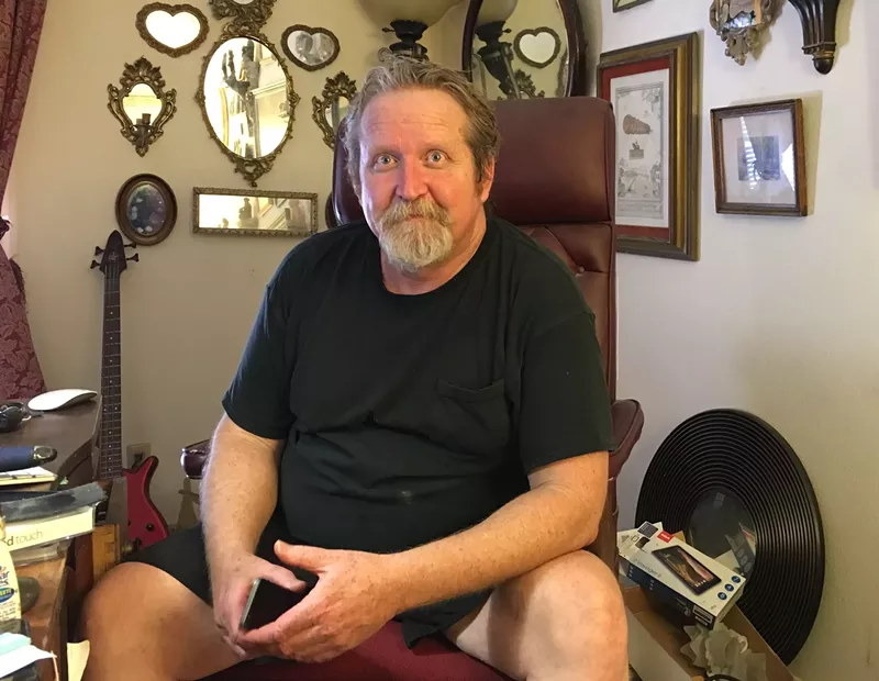 Image: Steve Gompf sits at his computer desk inside his home office in 2016.