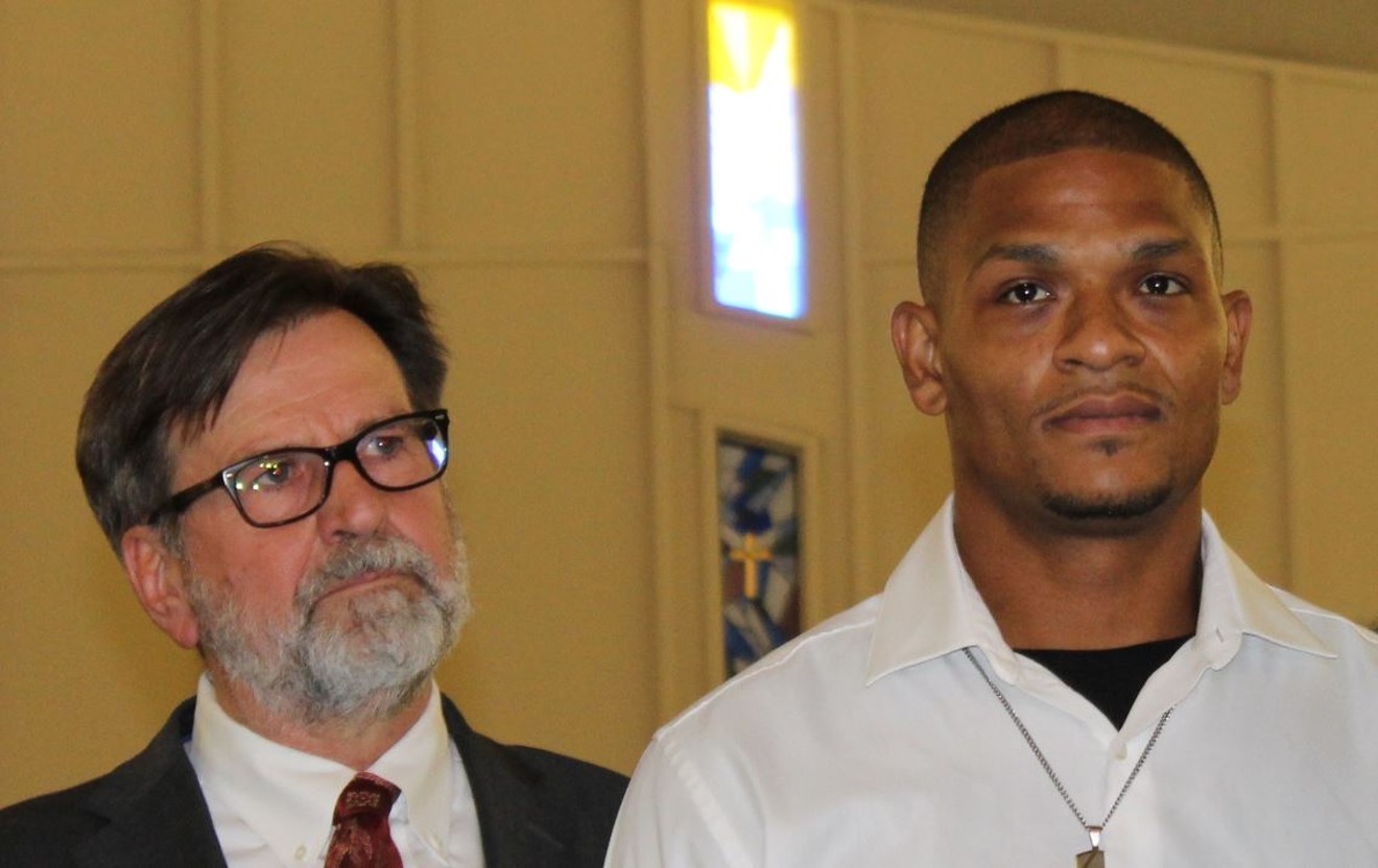 Robert Johnson Jr. (right) and lawyer Joel Robbins at a news conference in June.