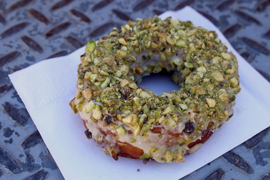 Orange glazed doughnut with pistachios