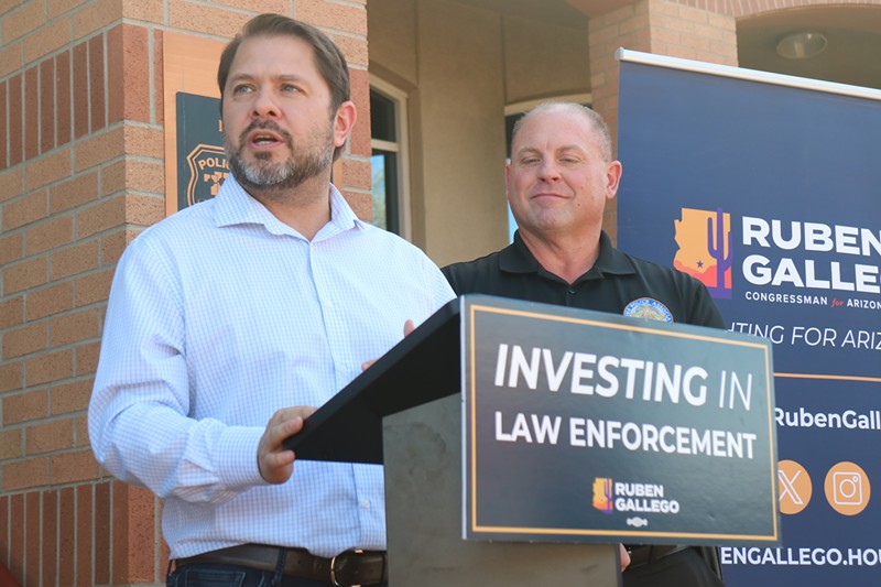 Ruben Gallego speaks at a press conference about his support of law enforcement. Glendale police Sgt. Justin Harris, the president of the Arizona Police Association, stands behind him.