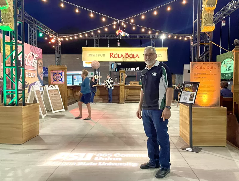 Image: Rúla Búla founder Steve Goumas stands at the entry to the pop-up pub at ASU's Mountain American Stadium.